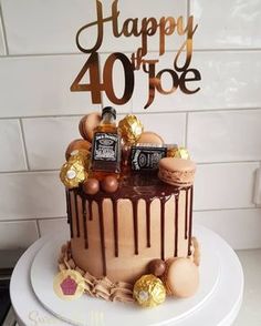 a birthday cake with chocolate and candies on top that says happy 40 three