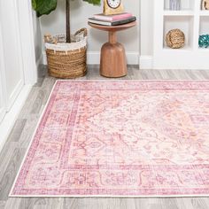 a pink area rug in front of a bookshelf with a clock on it