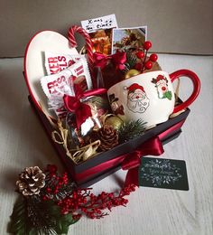 a heart shaped gift box filled with coffee and candy, christmas decorations and other items