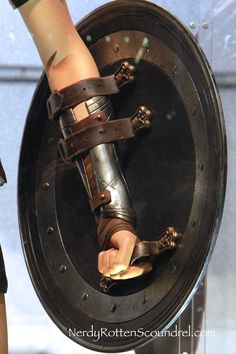 the legs and feet of a woman in gladia sandals on display at a museum