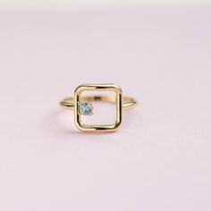 An open square ring in 14K solid gold with a natural aquamarine gemstone. A minimalist geometric ring for women for everyday use and a great gift for her by Kyklos Jewelry. ● Metal: 14K solid gold, 14K white gold  ● Square Dimensions: 11mm x 11 mm ● Gemstone: Aquamarine 0.11ct ● Choose from the drop down menus the available options (Material, Ring size) and leave us a note for any special requirements. ● All our pieces are delivered beautifully packaged and gift ready.  ● Please keep in mind tha Stacker Rings, Geometric Ring, Orange Sapphire, Square Rings, Gold Geometric, Solid Gold Rings, Aquamarine Gemstone, Natural Aquamarine, Stackable Rings