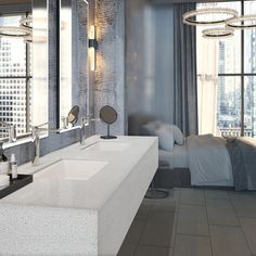 a modern bathroom with double sinks and large windows