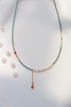 This delicate and vibrant necklace made of shimmering turquoise color beads, freshwater pearls, and gold accents adding a touch of summer accent to your wardrobe. Perfect as a thoughtful gift for anyone who loves jewelry that stands out with its vibrant yet elegant design. Treat yourself or someone special to this beautifully crafted piece! Details 3mm freshwater pearl 3mm CZ ruby gemstone 2mm Turquoise color metal plastic beads 40+5cm necklace chain with extender Turquoise Pearl Necklace With Colorful Beads As Gift, Gift Turquoise Beaded Necklace With Pearl Chain, Gift Turquoise Necklaces With Pearl Chain, Elegant Turquoise Pearl Necklace With Gemstone, Gift-ready Polished Turquoise Bead Necklace, Turquoise Choker, Turquoise Crystal, Crystal Bead Necklace, Ruby Gemstone