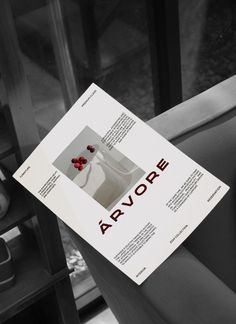 a magazine with the cover pulled up to show an image of a vase and flowers