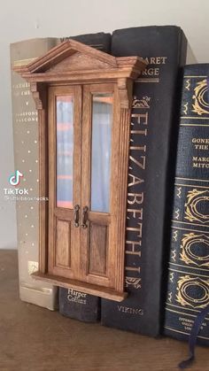 a wooden bookend sitting on top of a table next to two bookshelves