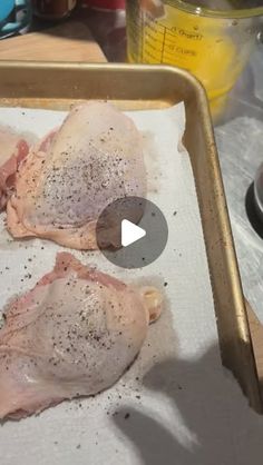 two raw chickens sitting on top of a pan