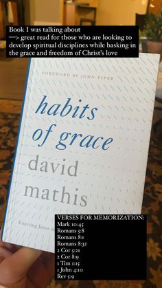 a person holding up a book in their hand with the title, habitts of grace