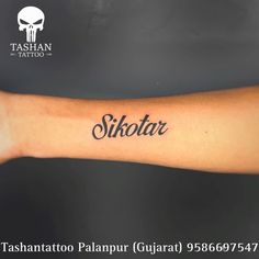 a person with a tattoo on their arm that says,'skotar '