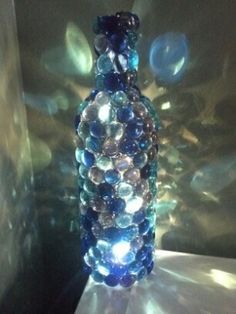 a blue glass bottle sitting on top of a table