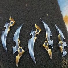 three different types of knives are laying on the ground