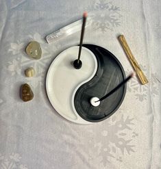 a yin - style plate with two chopsticks on it next to some rocks