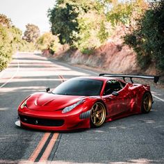 a red sports car is parked on the side of the road