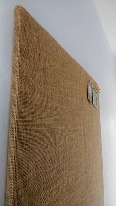 a close up of a bed with a headboard made out of burlap