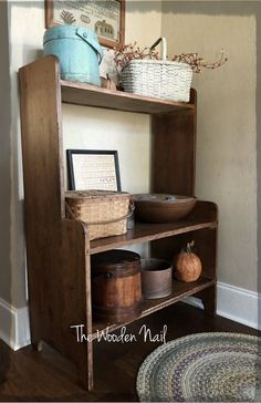 an old wooden shelf with baskets and other items on it