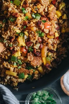 a pan filled with rice and vegetables on top of a table