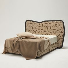 a bed with a blanket on top of it