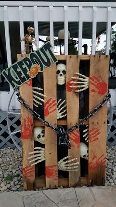 a wooden crate with skeletons in it and a sign that says happy halloween on the front