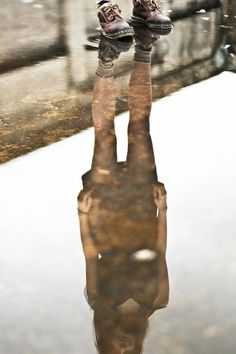 the reflection of a person's feet in water