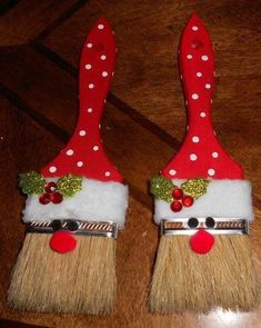 two red and white christmas decorations on top of brooms