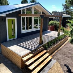 a house with a deck and steps leading up to the front door