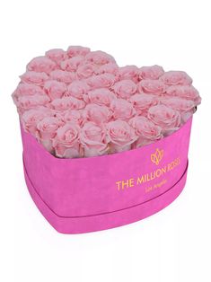 the million roses heart shaped box is pink with gold foil lettering on it and flowers inside