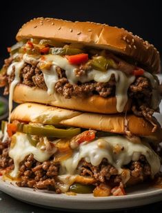 three cheeseburger sandwiches stacked on top of each other with peppers and onions in the middle