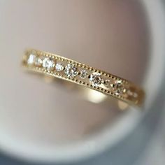 a close up view of a gold ring with small diamonds on the inside of it