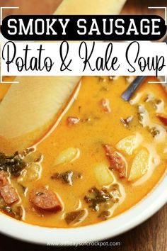 a bowl of smoky sausage potato and kale soup on a wooden table with a spoon