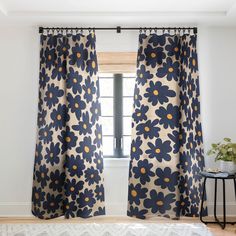 the curtains are hanging on the window sill in front of an open window with blue and yellow flowers