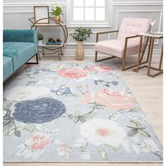 a living room with two chairs and a rug on the floor