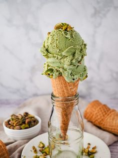 an ice cream cone with pistachio and pistachio on top, in a glass jar