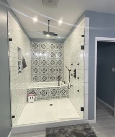 a bathroom with a walk in shower next to a toilet