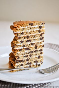 a stack of cookies and cream cake on a plate with a fork