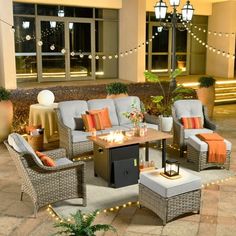 an outdoor patio with wicker furniture and string lights