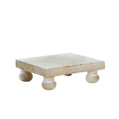 a small wooden table with two wheels on each side and a white surface in the middle