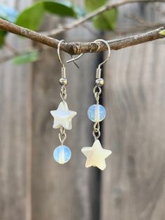 Enchanting opalite and mother of pearl dangly earrings silver metal alloy nickel free length 4 1/2 cm Comes with a silicone backing Handmade Jewelry Care: - Keep away from moisture - Put on after applying hair products, sprays, or lotions - Remove before sleep - Refrain from rigorous activities *Complimentary stickers included in every order Dangly Star Earrings, Celestial Star-shaped Hypoallergenic Earrings, White Celestial Dangle Earrings, Celestial Star Hypoallergenic Earrings, Celestial White Sterling Silver Earrings, White Sterling Silver Celestial Earrings, White Sterling Silver Earrings With Star Charm, White Celestial Star Earrings, Celestial White Star Earrings