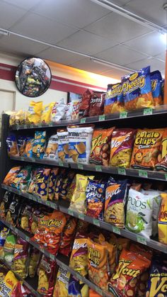 a store filled with lots of different types of chips and snacks on shelves next to each other