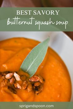 a close up of a bowl of soup with a leaf on top and the words savory butternut squash soup above it