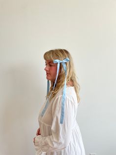 A playful spin on the classic hair bow, this micro bow with extra long tails makes a statement. Crafted out of 100% silk for a delicate drape and affixed to an alligator clip to easily wear in your hair or on the strap of a bag. Naturally dyed and hand crafted in our studio with love. Adjustable Blue Satin Bow, Adjustable Blue Ribbon Bow, Adjustable Blue Bow With Ribbon, Blue Hair Accessories For Summer Gift, Blue Bow Gift For Summer, Blue Adjustable Bow Hair Accessories, Adjustable Blue Bow Hair Accessories, Blue Ribbon Bow, Natural Indigo Dye