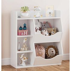 a white book shelf with stuffed animals and toys on it's shelves in a child's room