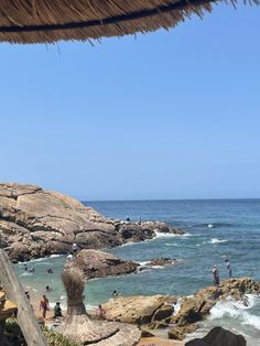 people are on the rocks near the water