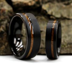 two black ceramic rings with wood inlays