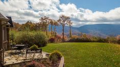 an outdoor patio with table and chairs overlooking the mountains