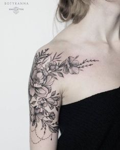 a woman with a flower tattoo on her shoulder