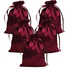 three red satin bags with ties on them