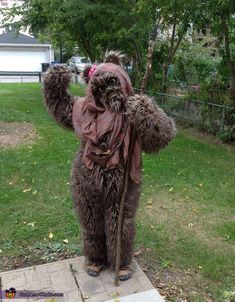 a person in a costume standing on a sidewalk