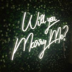 a neon sign that says will you marry me?