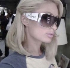 a blonde woman wearing sunglasses with the word paris on it's side and her name written on them