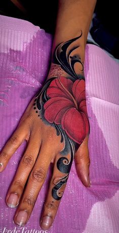 Tattoo Ideas Black Women Hand, Black Flower Tattoos For Women, Hibiscus Flower Hand Tattoo, Cute Girly Tattoos Ideas, Wrist Tattoos For Black Women, Hand Tattoo Cover Up Ideas, Full Hand Tattoos For Women, Colorful Tattoos For Black Women, Dope Hand Tattoos For Women