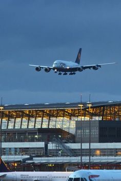 an airplane is flying low over the airport